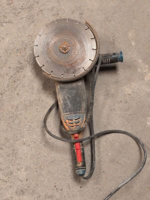 an image of a drill on the ground with a cord