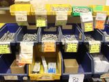many boxes of screws on the shelf in the store