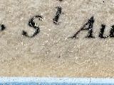 a close up of a sign on a wall near the water