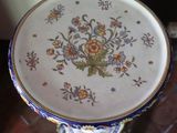 a blue and white plate with a floral design on it