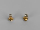 a pair of gold and diamond stud earrings