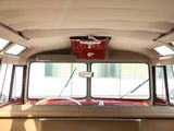 a red basket hanging from the ceiling of a bus
