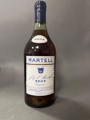a bottle of wine sitting on a table next to a bottle of wine