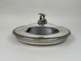 a silver plate with a bird on top of it