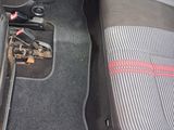the interior of a car with the front seats up and the floor mats down
