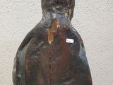 a statue of a man that is standing in front of a wall
