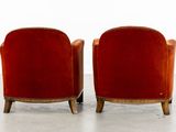 pair of red velvet club chairs with wooden legs