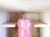 a bottle of wine sitting on a shelf in a room
