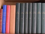 many books that are in a box on the shelf