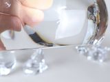 a person pouring water into a glass with ice cubes