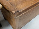 a wooden chest with a drawer on top of it