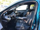 the interior of a blue car with black leather seats and a steering wheel