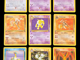 the pokemon cards are lined up on a black surface