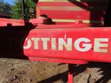 a close up of a red tractor with a sign on it