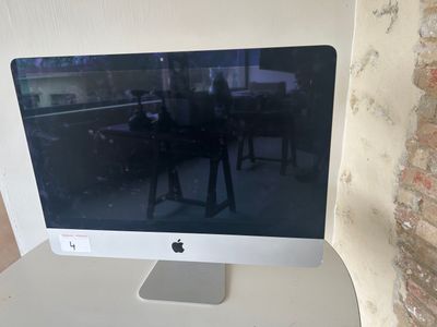 a computer monitor sitting on top of a white desk