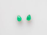 une paire de boucles d'oreilles en émeraude sur fond blanc
