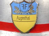 a close up of a metal helmet with a blue and yellow emblem