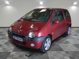 a small red car that is parked in a garage