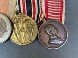 three medals are sitting on a table with a red, white, and blue ribbon