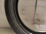 a close up of a tire on a shelf with a piece of paper