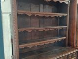 a wooden cabinet with a wine rack on top of it
