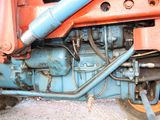 a close up of a tractor with a hose attached to the back of it