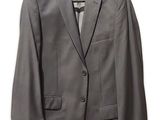 grey suit on a hanger on a hanger on a white wall