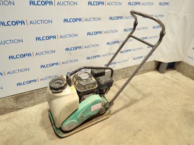 an image of a lawn mower parked in front of a wall