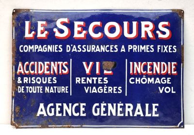 blue and red sign on a white wall with french writing
