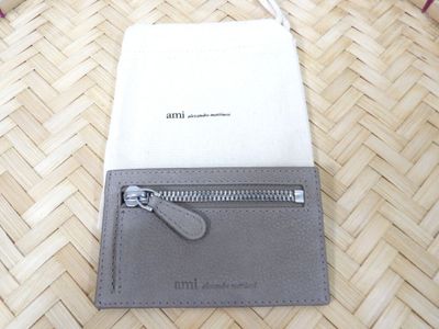 a wallet with a zipper on it sitting on the floor