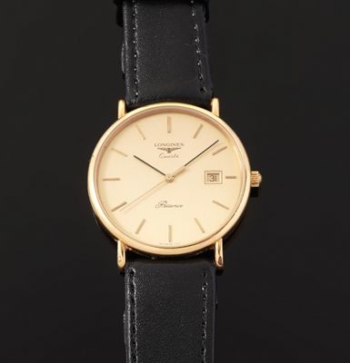 a close up of a gold wrist watch on a black background