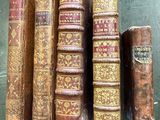 many old books lined up on a table