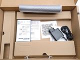 a box with a laptop and a charger inside of it