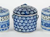 three blue and white jars sitting next to each other