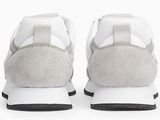 the white and grey sneakers are lined up on a white surface