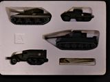 four different types of toy tanks in a box