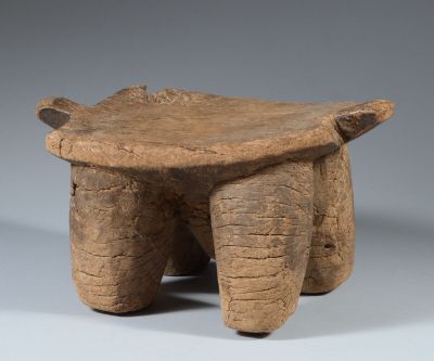 an old wooden stool with two legs and a seat made of wood