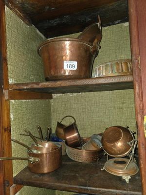 many pots and pans on the shelves in the kitchen