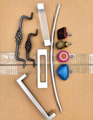 a cardboard box with various tools on it, including a hammer, a wrench, and a ball