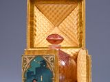 a small box with a figurine inside of it