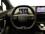 the interior of a car with a steering wheel and a display screen