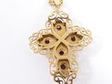 an image of a gold cross with garnets on a chain
