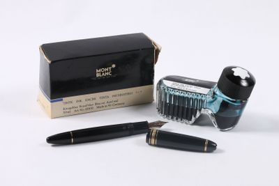 a pen and a brush sitting next to a box of ink