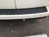 a close up of a white car with a black bumper
