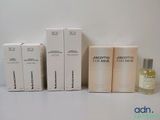 three boxes of perfume sitting next to each other on a table