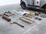 a car that is sitting on the floor next to other items