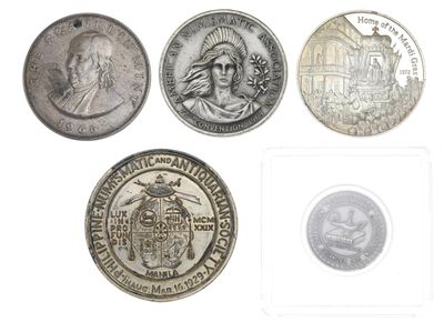 several different coins are shown in a row on a white surface