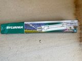 a toothbrush sitting on the floor next to a box of toothpaste