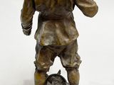 bronze statue of a boy with a dog on a marble base