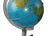 a small blue globe on a metal stand on a white background